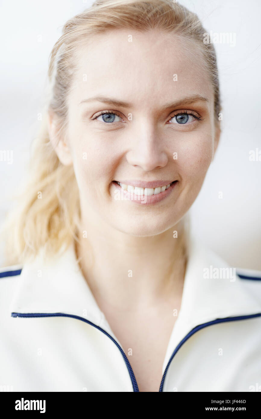 Portrait of young woman smiling and looking at camera Stock Photo - Alamy