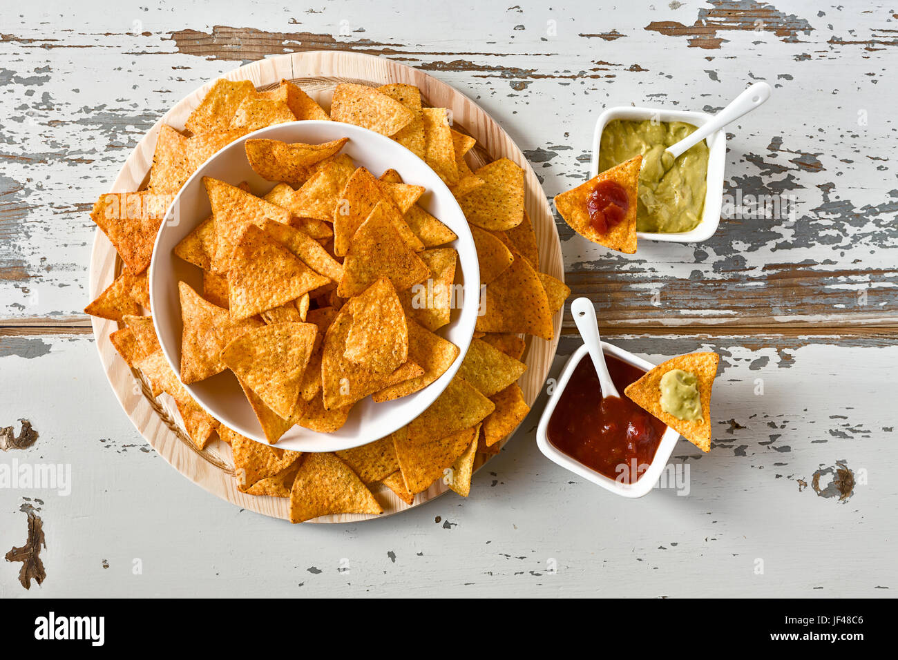 Nachos in a white bowl and sauces Stock Photo