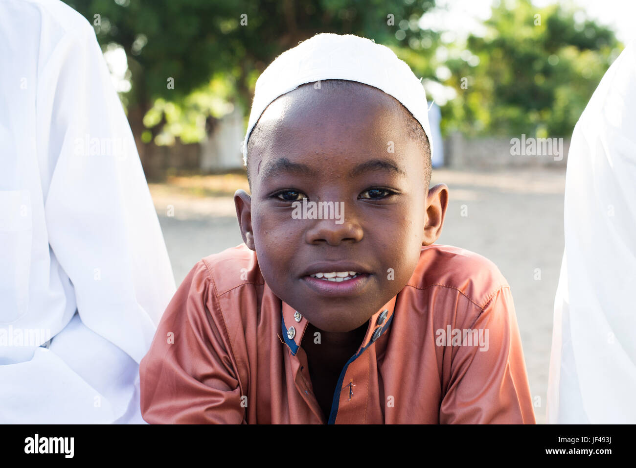 Young boy dressed in traditional kanzu and kofia (embroidered hat) attends the Maulidi celebrations on Lamu island, Kenya Stock Photo
