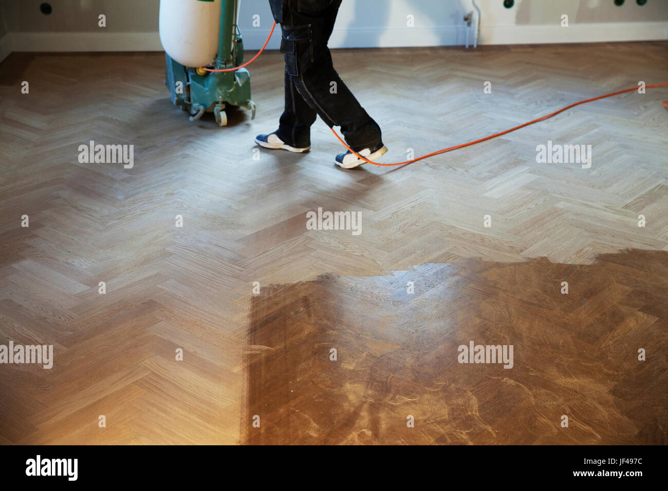 Man cleaning wooden floor with floor polisher Stock Photo Alamy