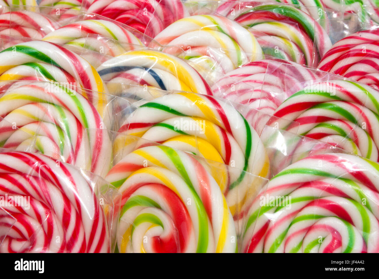 Colorful whirly lolly pops wrapped in cellophane, detail Stock Photo