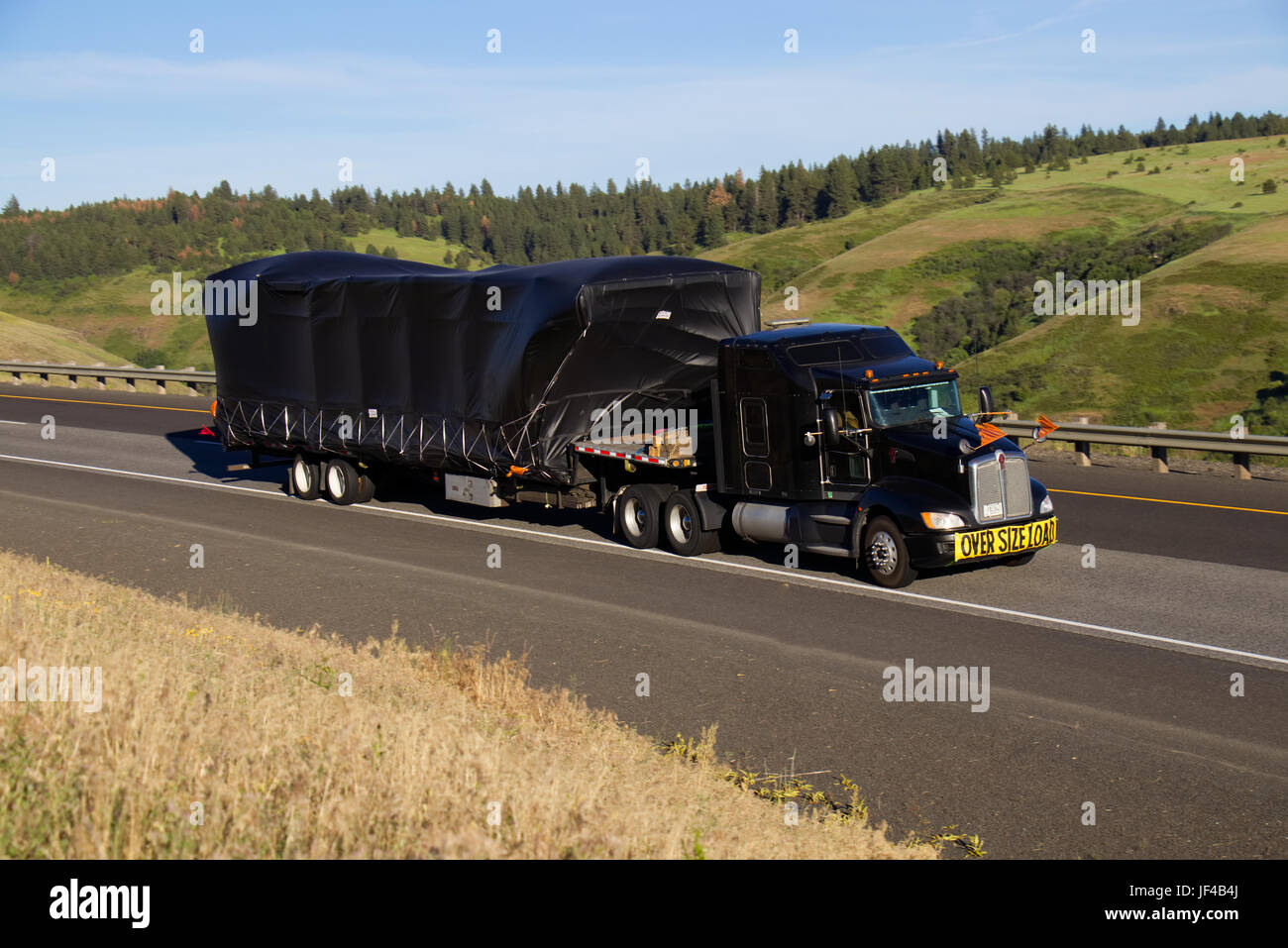 Oversize Load / Black Kenworth Semi-Truck Stock Photo