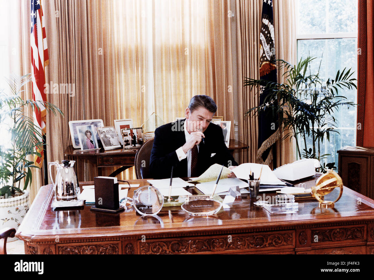 President Ronald Reagan at work in the Oval Office. Stock Photo