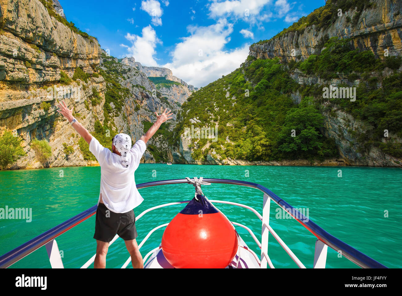 The enthusiastic tourist on  boat Stock Photo