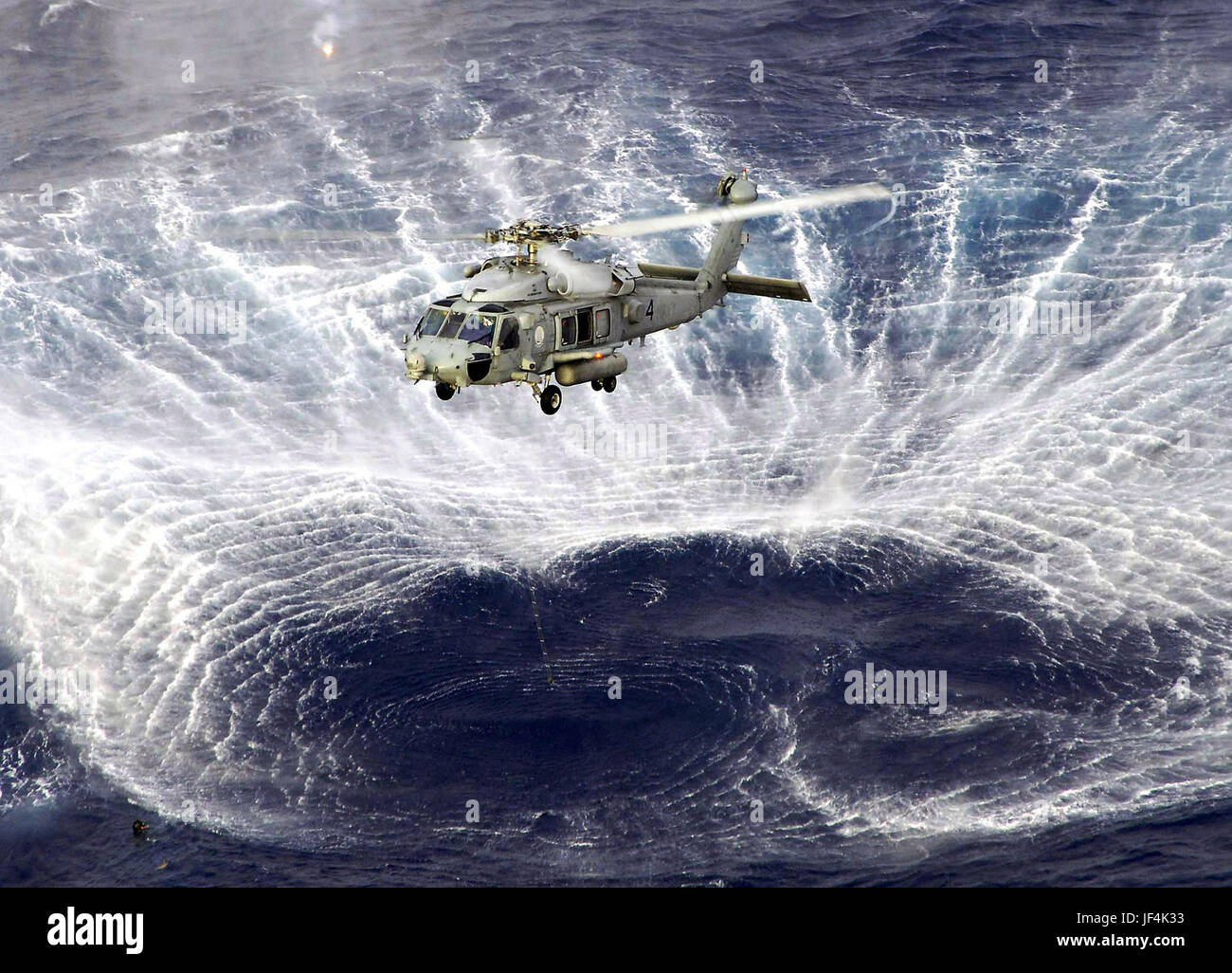 Rotor wash off a Navy SH60F Seahawk helicopter kicks up a circle of