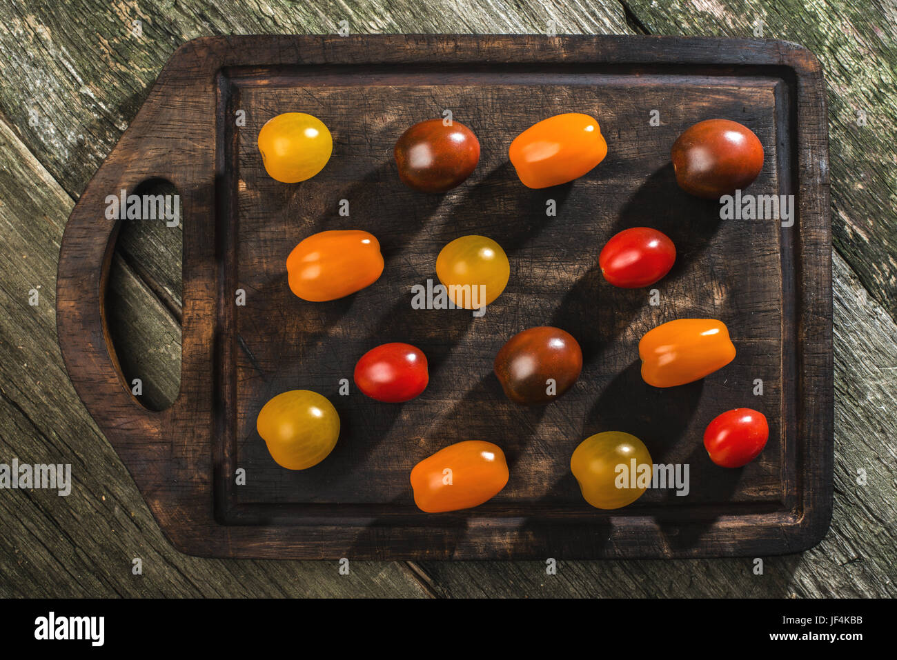 Variety of cherry tomatoes on wood Stock Photo - Alamy