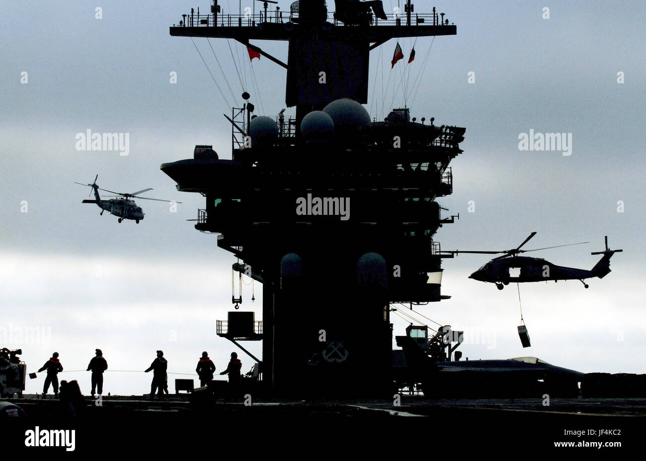 Navy MH-60S Seahawk helicopters airlift ammunition from the aircraft carrier USS Nimitz (CVN 68) to the Military Sealift Command fast combat support ship USNS Bridge (T-AOE 10) as the two ships operate in the Pacific Ocean. DoD photo by Airman Ashley Gayton, U.S. Navy Stock Photo