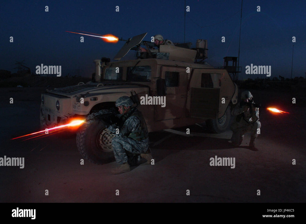 050730-N-6501M-100  U.S. Army Spc. Ronnie Scibek (top), Sgt. Glenn Santos (left) and Spc. Kyle Hurt participate in a nighttime live fire training exercise at the Iraqi Army Compound firing range on Forward Operating Base Iskandariyah, Iraq, on July 30, 2005.  The soldiers are attached to Bravo Company, 490th Civil Affairs Battalion, 155th Brigade Combat Team. DoD photo by Chief Petty Officer Edward G. Martens, U.S. Navy.  (Released) Stock Photo