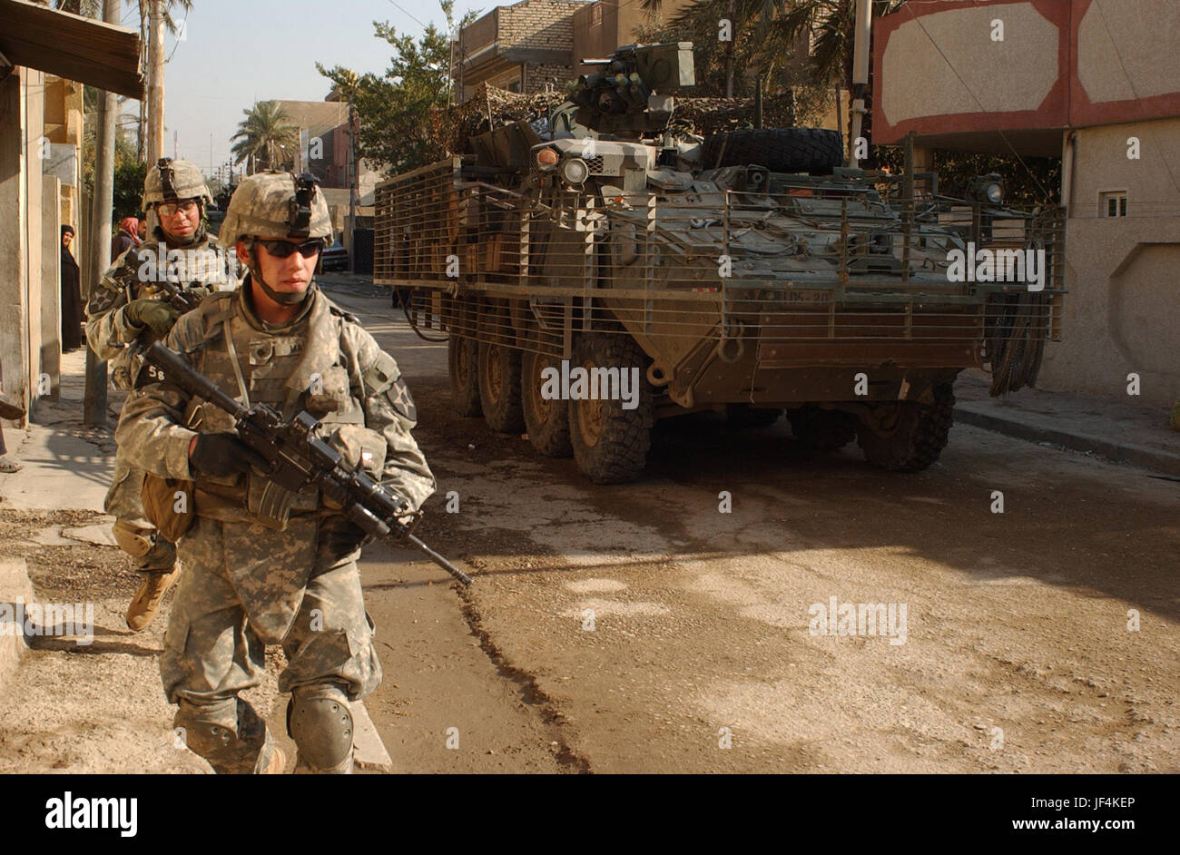 061211-A-0350A-084         U.S. Army soldiers from 5th Battalion, 20th Infantry Regiment provide security for Iraqi army soldiers during a patrol in Adhamiya, Iraq, on Dec. 11, 2006.  The intent of the patrol is to decrease sectarian violence and insurgent activity while increasing the Iraqi security force's capabilities.  DoD photo by Spc. Jeffrey Alexander, U.S. Army.  (Released) Stock Photo