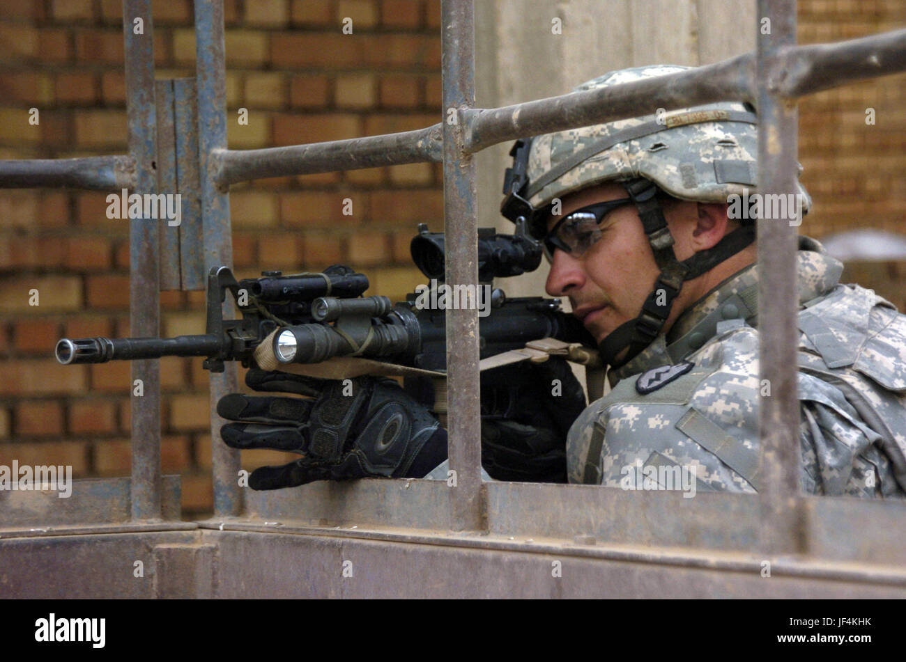 061115-A-2519G-063         U.S. Army Spc. Bruce Blachly of Delta Company, 2nd Battalion, 27th Infantry Regiment uses the scope on his M 4 rifle to scan the distance during a joint U.S. and Iraqi cordon and search operation conducted in the Patika province of Iraq on Nov. 15, 2006. DoD photo by Sgt. 1st Class Michael Guillory, U.S. Army.  (Released) Stock Photo