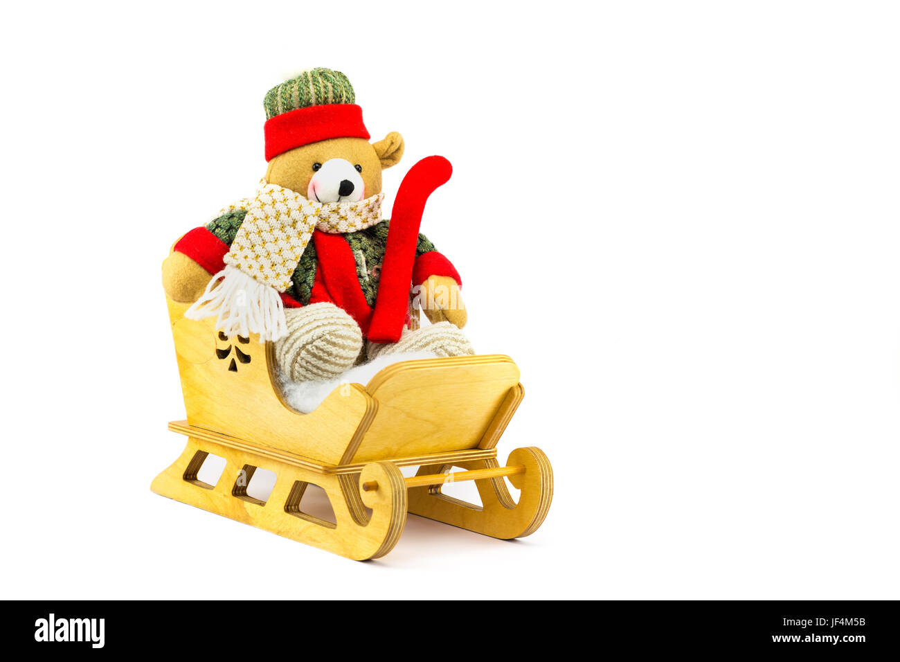 Christmas bear in wooden sleigh on white Stock Photo