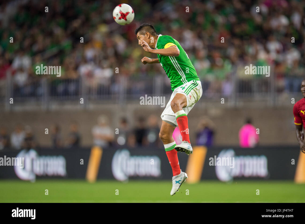 Houston, TX, USA. 28th June, 2017. Mexico defender Hugo Ayala (4) heads the ball during the 1st half of an international soccer friendly match between Mexico and Ghana at NRG Stadium in Houston, TX. Trask Smith/CSM/Alamy Live News Stock Photo