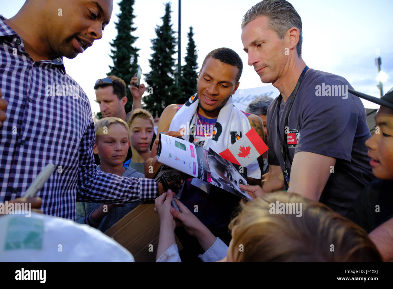 Coquitlam, British Columbia, Canada. 28th June, 2017. Canada's Andre De Grasse signs autographs after winning the men's 100-metre event on Wednesday night at the 2017 Vancouver Sun Harry Jerome Track Classic at Percy Perry stadium in Coquitlam. Joe Ng/Alamy Live News Stock Photo