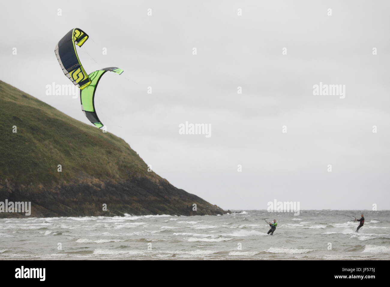 Swansea, UK. 29th June, 2017. Blown away: kite surfers make the most of the strong north westerly breeze at Broughton bay on the Gower peninsula.  Credit: Gareth Llewelyn/Alamy Live News Stock Photo