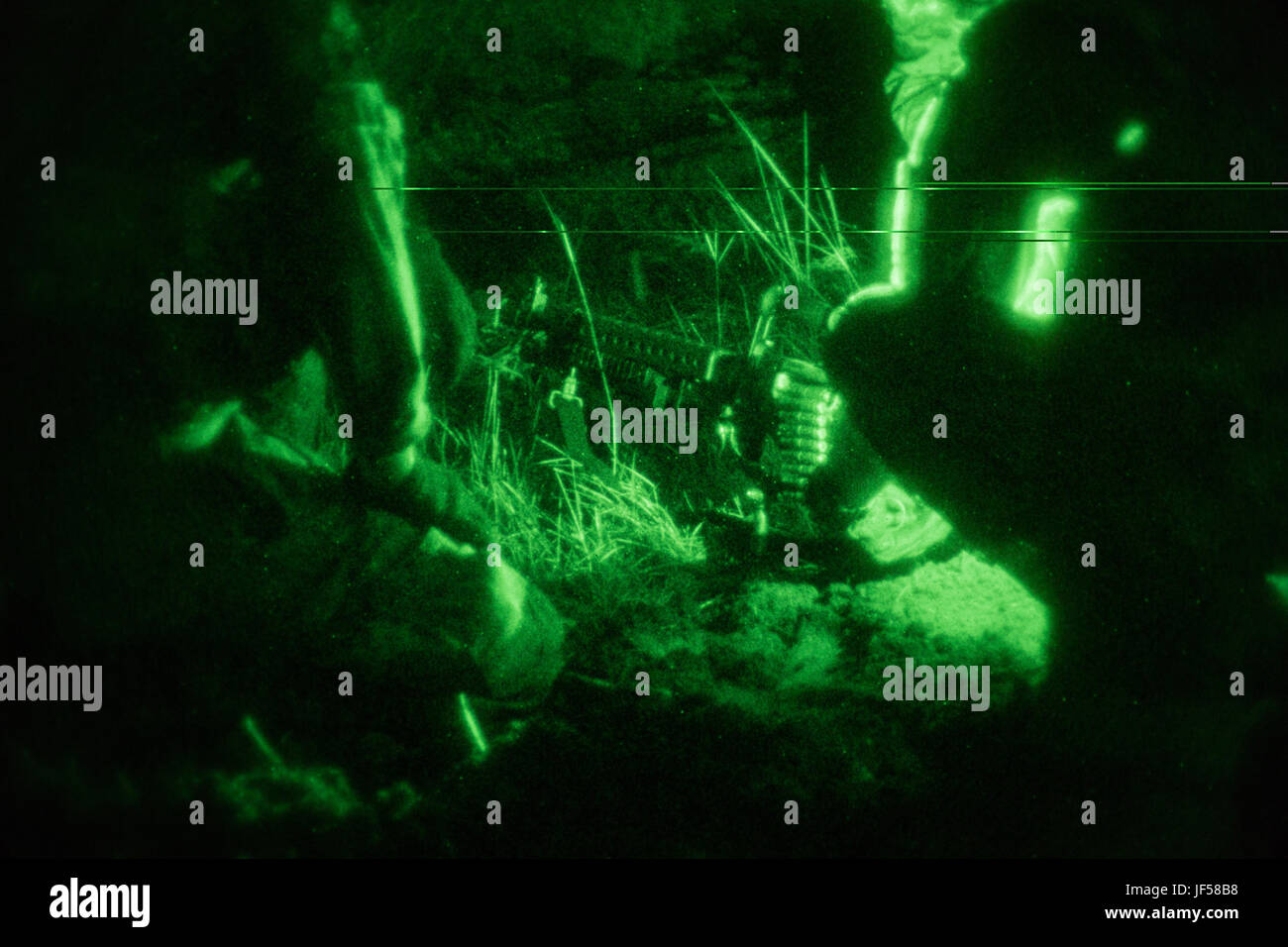 U.S. Soldiers assigned to the 1st Battalion, 506th Infantry Regiment, 1st, Brigade Combat Team, 101st Airborne Division fix a malfunction with a M240B machine gun during United Accord 2017 at Bundase Training Camp, Bundase, Ghana, May 26, 2017. United Accord (formerly Western Accord) 2017 is an annual, combined, joint military exercise that promotes regional relationships, increases capacity, trains U.S. and Western African forces, and encourages cross training and interoperability. (U.S. Army photo by Spc. Victor Perez Vargas) Stock Photo