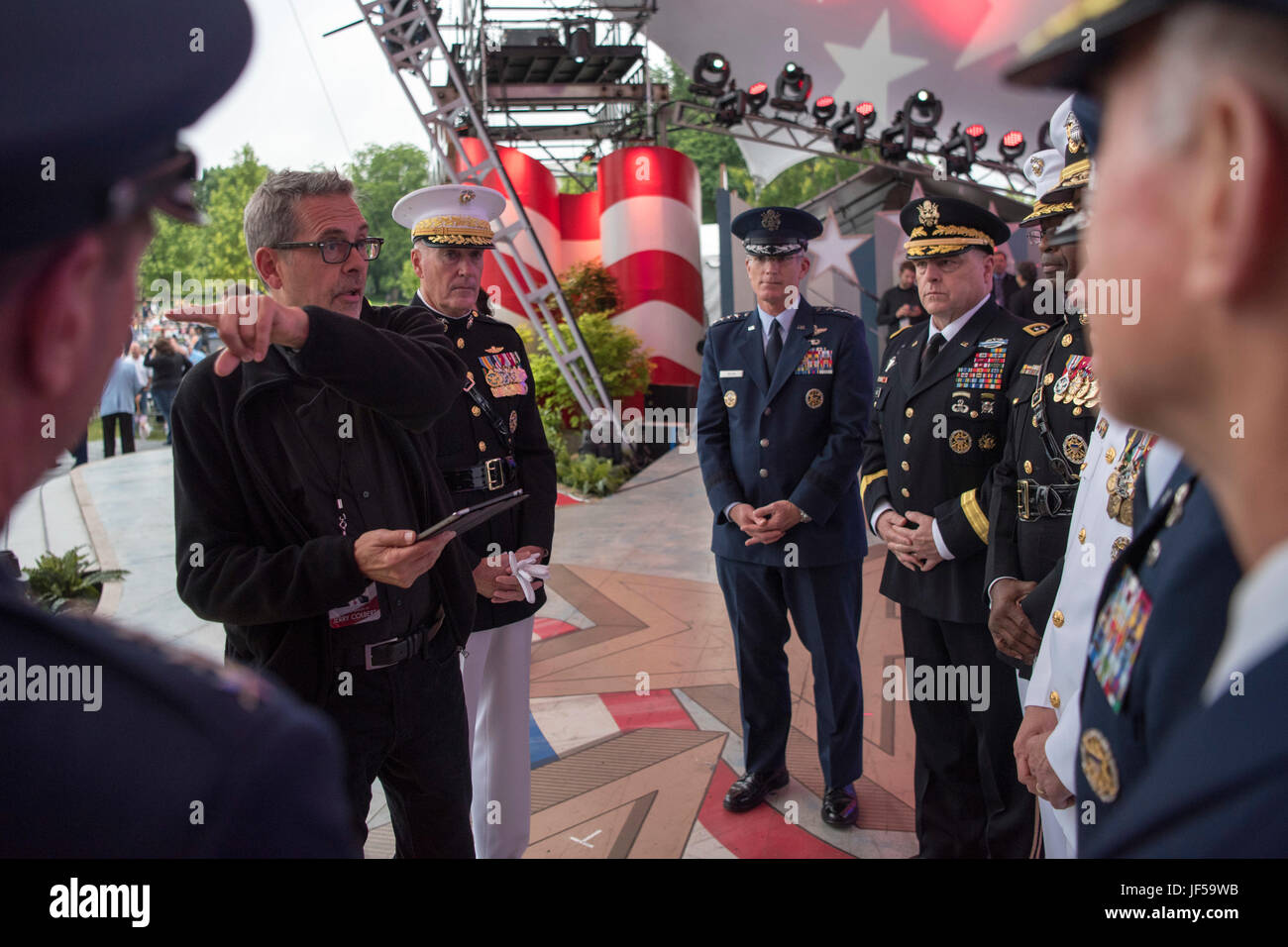 A stage manager gives instruction Marine Corps Gen. Joseph F. Dunford Jr., chairman of the Joint Chiefs of Staff, and the Joint Chiefs before the National Memorial Day Concert at the west lawn of the U.S. Capitol, Washington, D.C., May 28, 2017. The concert’s mission is to unite the country in remembrance and appreciation of the fallen and to serve those who are grieving. (Dept. of Defense photo by Navy Petty Officer 2nd Class Dominique A. Pineiro/Released) Stock Photo