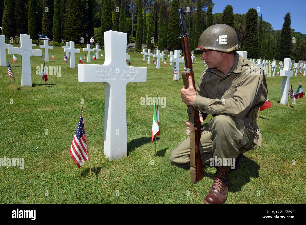 Re-enactment World War II-era actor kneel before a grave marker during the  Memorial Day ceremony at the Florence American Cemetery and Memorial,  Florence, Italy, May 29, 2017. (U.S. Army Photo by Visual