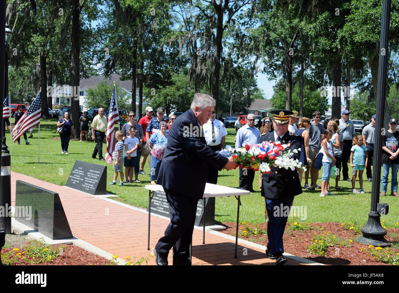 Harold Fowler, mayor of Richmond Hill, Ga., and Lt. Col. Chris McCreery, commander of the 87th Combat Sustainment Support Battalion, 3rd Infantry Division Sustainment Brigade, carry a wreath to the Richmond Hill Veterans’ Monument during the Richmond Hill Memorial Day Observance May 29. Including McCreery as the guest speaker, the event hosted speakers from local Veterans of Foreign Wars and American Legion posts. (U.S. Army photo by Sgt. 1st Class Ben K. Navratil) Stock Photo