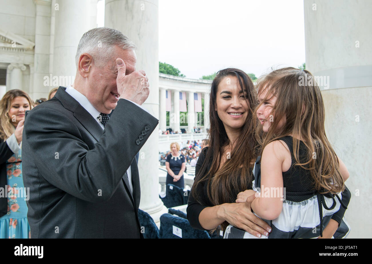 Secretary of Defense Jim Mattis plays peek-a-boo with Leilani, 3, as she is held by her mother Destiny Flynn before a Memorial Day ceremony at Arlington National Cemetery in Arlington, Va., May 29, 2017. Leilani's father and Destiny's husband, U.S. Marine Corps Staff Sgt. Liam Flynn, died during a training accident in 2015. (DOD photo by U.S. Air Force Tech. Sgt. Brigitte N. Brantley) Stock Photo