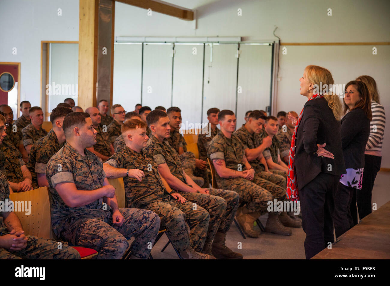 Gail Walters, wife of Gen. Glenn Walters, the Assistant Commandant of the Marine Corps, along with the wives of Sgt. Maj. Robert VanOostrom, the sergeant major of Manpower and Reserve Affairs and Lt. Gen. Michael Dana, deputy commandant of Installations and Logistics, addresses the married Marines and sailors of Marine Rotational Force Europe 17.1 in Værnes Garnison, Norway, May 29, 2017. The ladies talked with Marines about strategies for keeping in touch with spouses and children back home during deployment. (U.S. Marine Corps photo by Cpl. Emily Dorumsgaard) Stock Photo