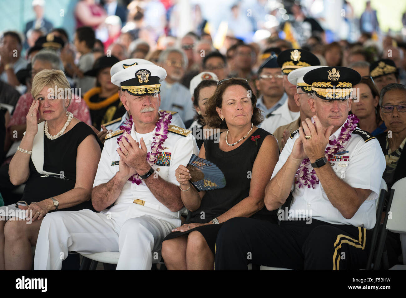 170529-N-ON707-152HONOLULU (May 29, 2017)—Adm. Scott Swift, Commander of U.S. Pacific Fleet and Gen. Robert B. Brown, Commanding General of U.S. Army Pacific, clap during the Memorial Day Ceremony at the 68th annual Memorial Day Ceremony at the National Memorial Cemetery of the Pacific. Active-duty military, decorated veterans, government officials, community and family members gathered during the ceremony to remember and honor fallen military veterans. (U.S. Navy photo by Mass Communication Specialist 2nd Class James Mullen/Released) Stock Photo