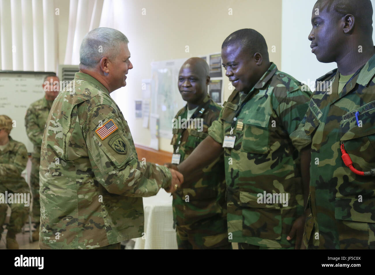 U.S. Army Brig. Gen. Kenneth Moorer, Deputy Commander U.S. Army Africa, presents a U.S. Army Africa coin to United Accord 2017 participants at the Kofi Annan International Peacekeeping Training Centre in Accra, Ghana, May 30, 2017. United Accord (formerly Western Accord) 2017 is an annual, combined, joint military exercise that promotes regional relationships, increases capacity, trains U.S. and Western African forces, and encourages cross training and interoperability. (U.S. Army photo by Pfc. Joseph Friend) Stock Photo