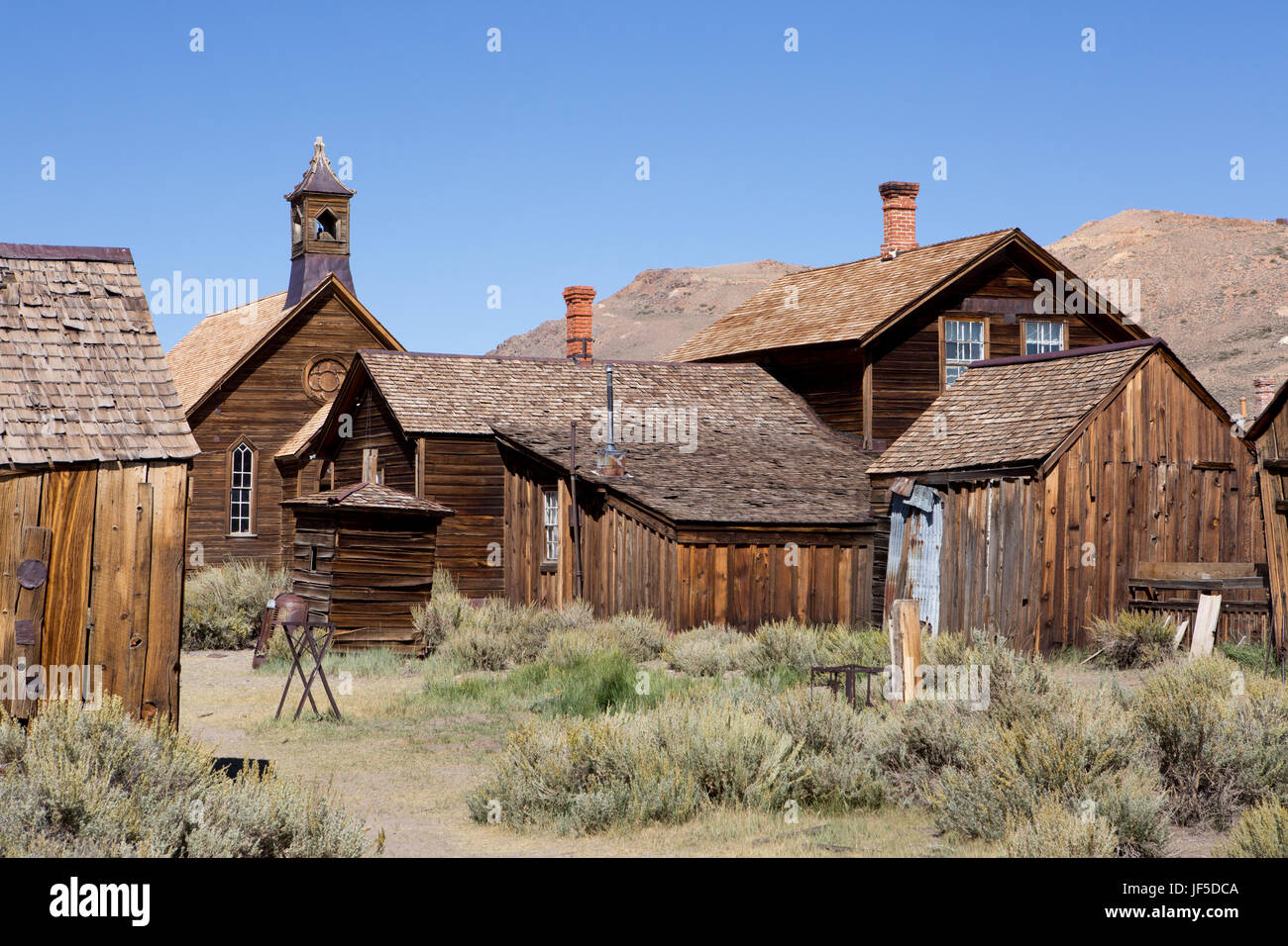 A church and several abandoned homes in Bodie Ghost Town. Stock Photo