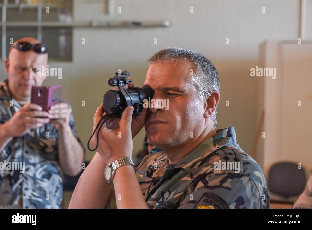 Col. Nikolay Lyaskovski, head of Force Protection in the Branch of Training Department for the Bulgarian Air Force, examines a night vision lens on May 31, 2017 at Berry Field Air National Guard Base, Nashville, Tenn. Tennessee partners with Bulgaria under the State Partnership Program, which is designed to train allied forces, build international relationships, and enhance regional security. (U.S. Air National Guard photo by Senior Airman Anthony Agosti) Stock Photo