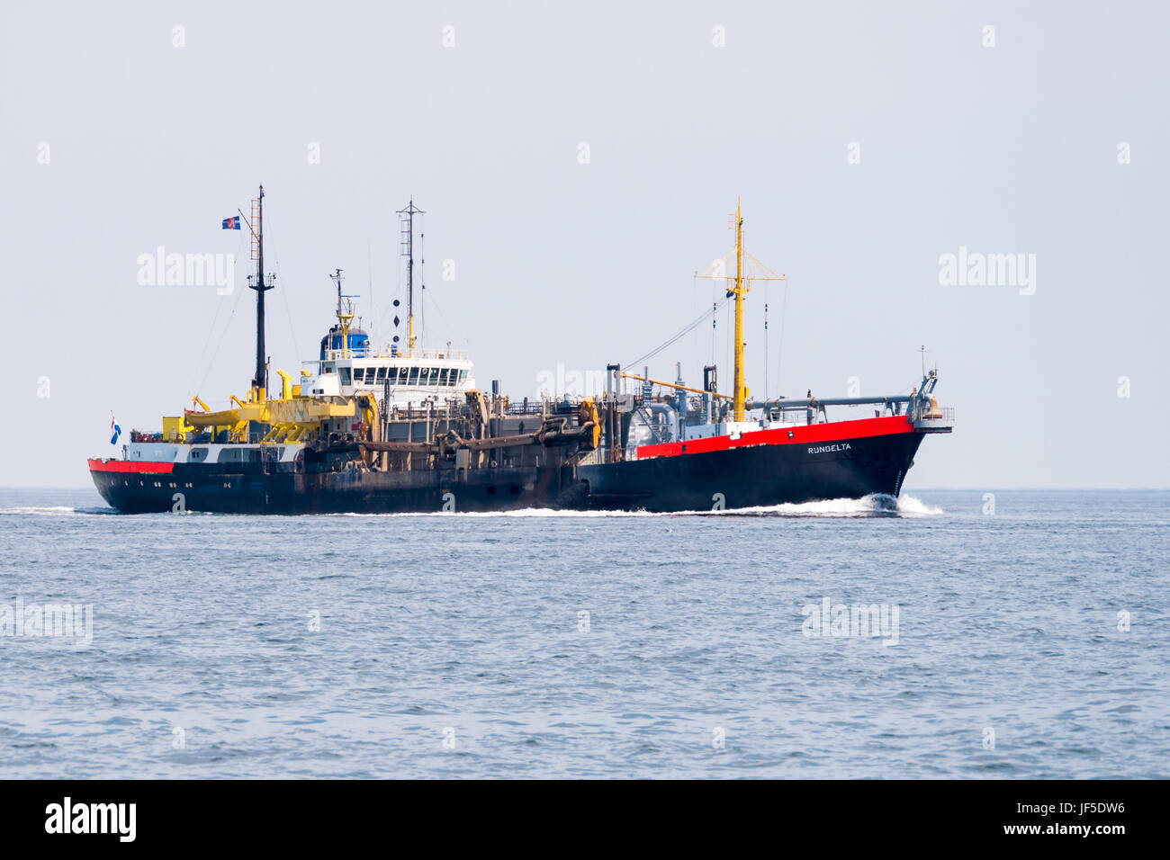 Trailing suction hopper dredger ship discharging at North Sea near port ...