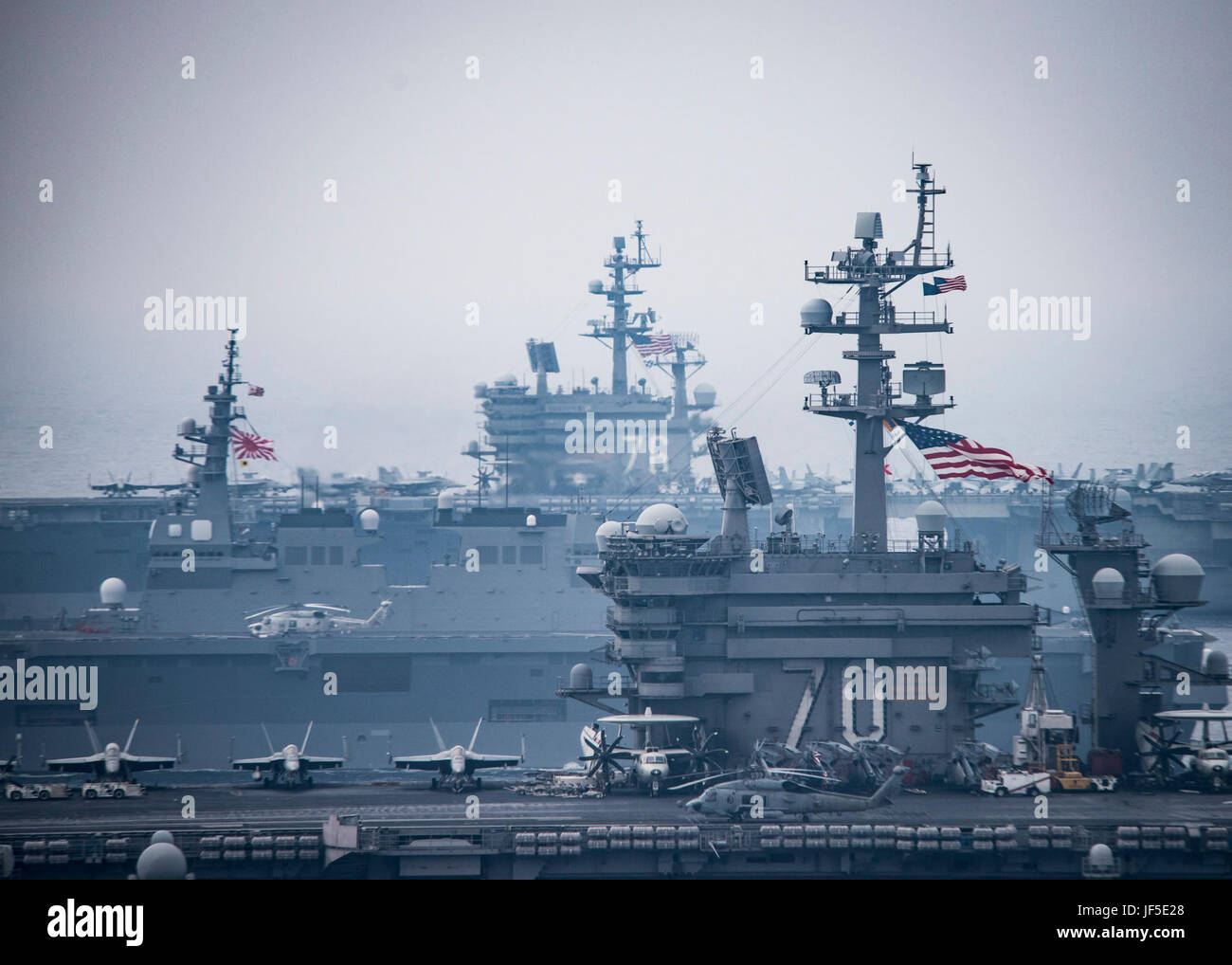 170601-N-GD109-070 SEA OF JAPAN (June 1, 2017) The Carl Vinson strike group, including USS Carl Vinson (CVN 70), Carrier Air Wing (CVW) 2, guided-missile cruiser USS Lake Champlain (CG 57) and guided-missile destroyers USS Wayne E. Meyer (DDG 108) and USS Michael Murphy (DDG 112), operates with the Ronald Reagan strike group including, USS Ronald Reagan (CVN 76), Carrier Air Wing (CVW) 5, guided-missile cruiser USS Shiloh (CG 67), guided-missile destroyers USS Barry (DDG 52), USS McCampbell (DDG 85), USS Fitzgerald (DDG 62), and USS Mustin (DDG 89) and the Japanese Ships (JS) Hyuga (DDH 181) a Stock Photo