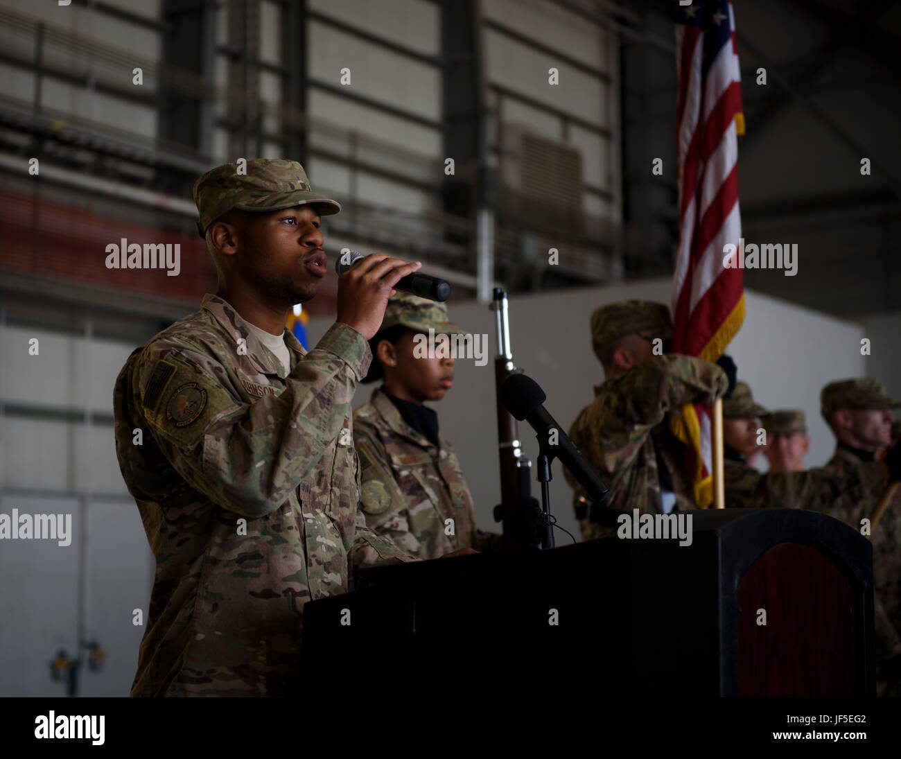 Senior Airman Calvin Johnson, 455th Expeditionary Security Forces Squadron, sings the national anthem during a change of command ceremony at Bagram Airfield, Afghanistan, June 3, 2017. During the ceremony, Brig. Gen. Jim Sears relinquished command of the 455th Air Expeditionary Wing to Brig. Gen. Craig Baker. (U.S. Air Force photo by Staff Sgt. Benjamin Gonsier) Stock Photo
