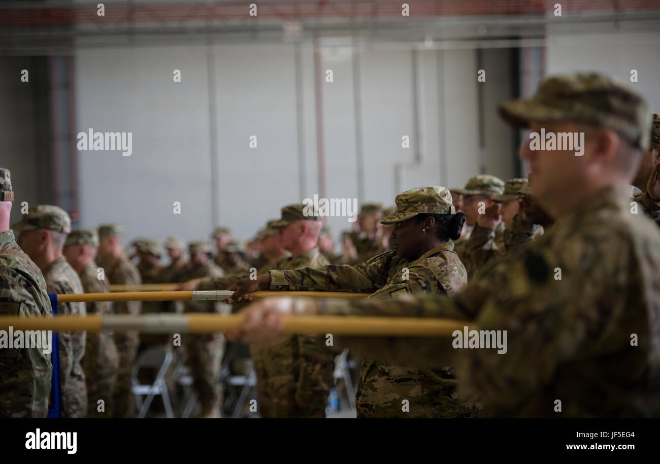 Airmen from the 455th Air Expeditionary Wing lower their group guidons as the national anthem is sung during a change of command ceremony at Bagram Airfield, Afghanistan, June 3, 2017. During the ceremony, Brig. Gen. Jim Sears relinquished command of the 455th AEW to Brig. Gen. Craig Baker. (U.S. Air Force photo by Staff Sgt. Benjamin Gonsier) Stock Photo