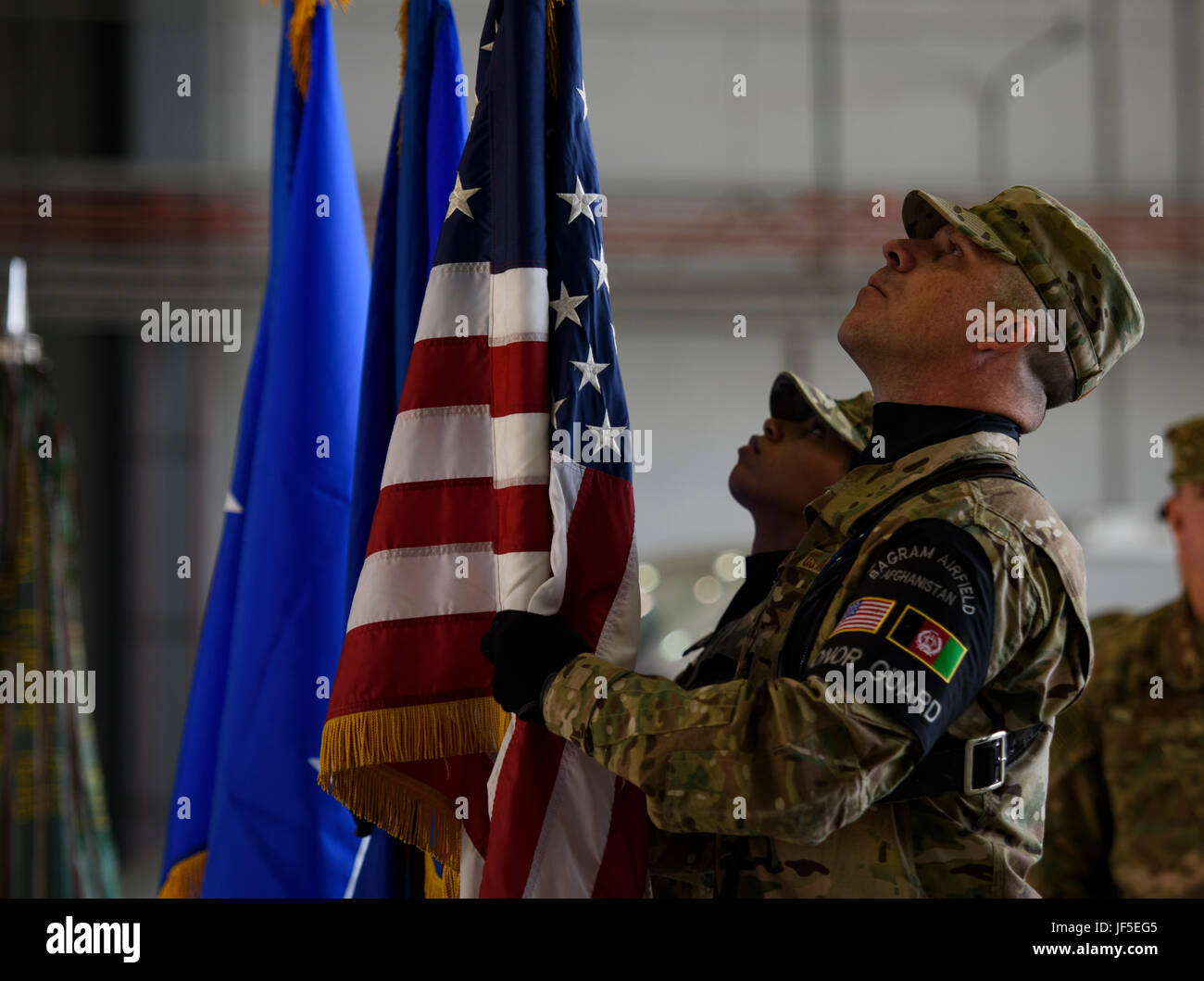 Bagram Honor Guard members set the American and U.S. Air Force flag during a change of command ceremony at Bagram Airfield, Afghanistan, June 3, 2017. During the ceremony, Brig. Gen. Jim Sears relinquished command of the 455th Air Expeditionary Wing to Brig. Gen. Craig Baker. (U.S. Air Force photo by Staff Sgt. Benjamin Gonsier) Stock Photo