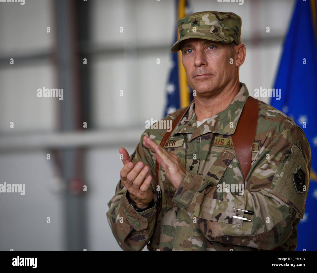 Brig. Gen. Craig Baker, the 455th Air Expeditionary Wing commander, gives a round of applause during a change of command ceremony at Bagram Airfield, Afghanistan, June 3, 2017. As the commander of the 455th AEW, Baker will lead the premier counterterrorism air mission in Afghanistan. The wing’s operations enable the NATO Resolute Support mission to successfully train, advise, and assist the military and security forces of Afghanistan, while restricting and deterring the terrorist threat in the region. (U.S. Air Force photo by Staff Sgt. Benjamin Gonsier) Stock Photo