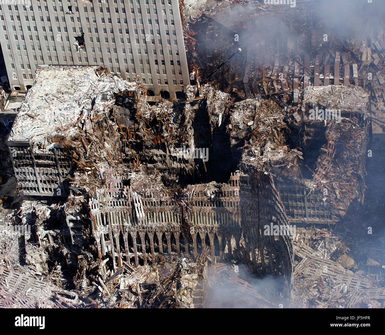 010917-N-7479T-515 Ground Zero, New York City, N.Y. (Sept. 17, 2001) -- An aerial view shows only a small portion of the crime scene where the World Trade Center collapsed following the Sept. 11 terrorist attack.  Surrounding buildings were heavily damaged by the debris and massive force of the falling twin towers.  Clean-up efforts are expected to continue for months.  U.S. Navy photo by Chief Photographer's Mate Eric J. Tilford. Stock Photo