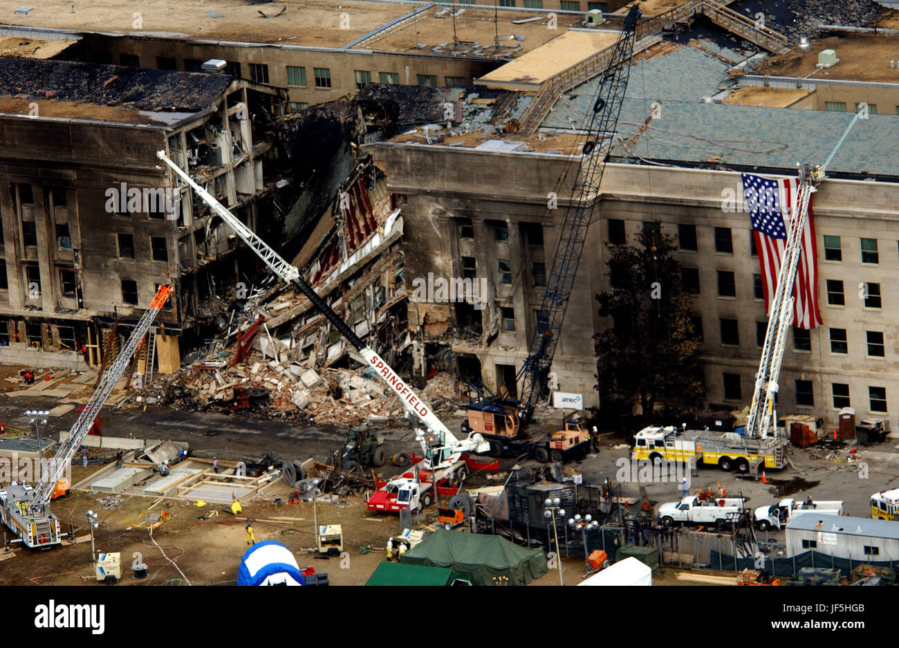 FBI agents, fire fighters, rescue workers and engineers work at the Pentagon crash site on Sept. 14, 2001, where a high-jacked American Airlines flight slammed into the building on Sept. 11.  The terrorist attack caused extensive damage to the west face of the building and followed similar attacks on the twin towers of the World Trade Center in New York City.   DoD photo by Tech. Sgt. Cedric H. Rudisill. Stock Photo