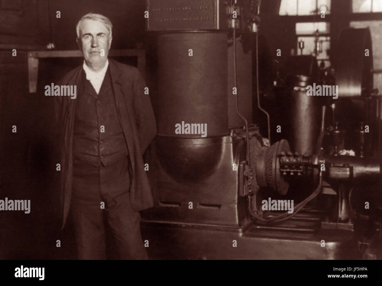 Thomas Alva Edison (1847–1931), American inventor and businessman, standing with his original dynamo at Edison Works in Orange, New Jersey, c1906. Stock Photo