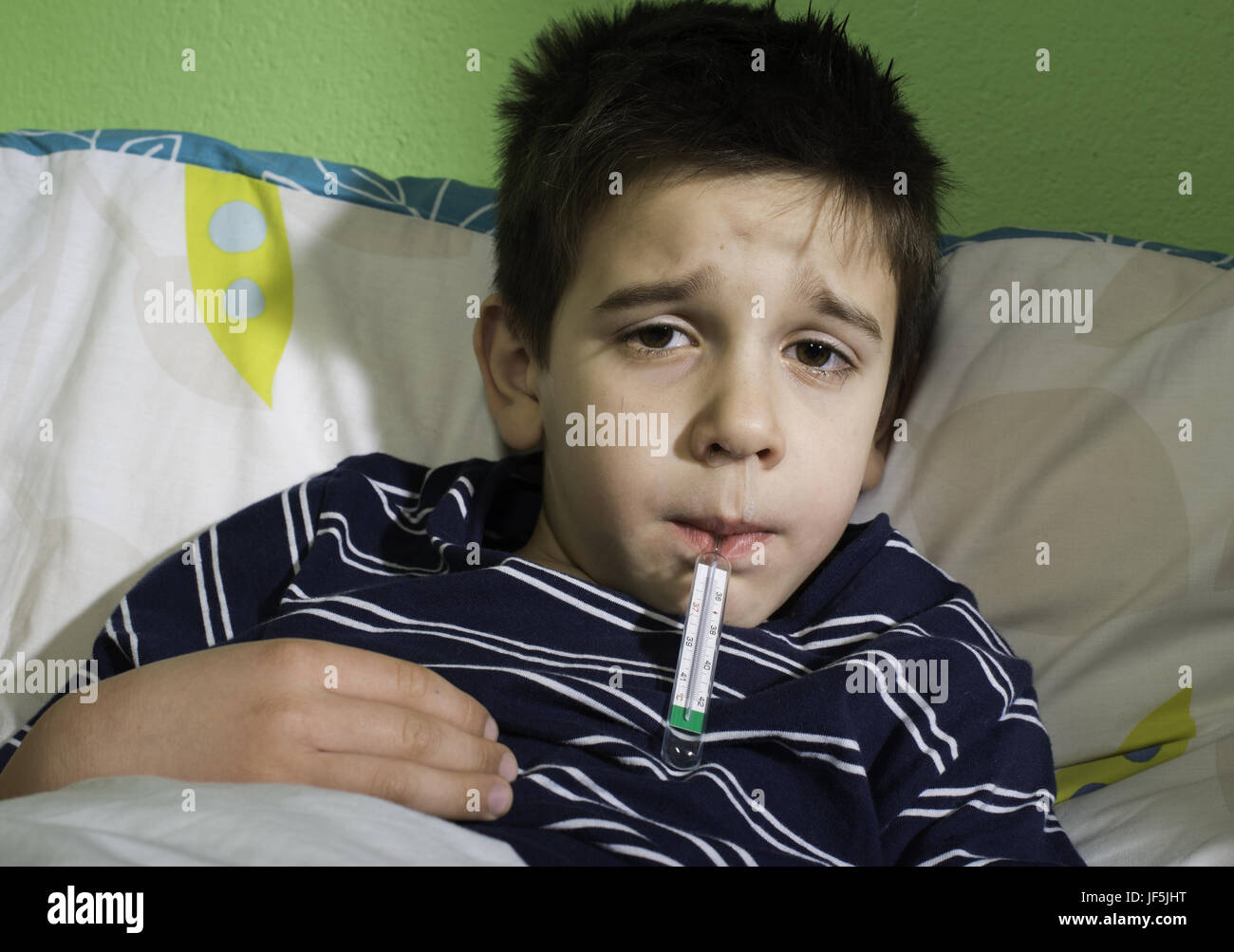 Sick child in bed Stock Photo - Alamy