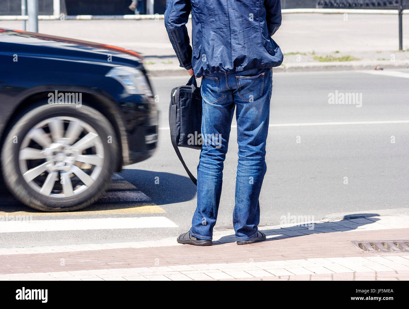waiting man at the pedestrian crossing and car traffic Stock Photo - Alamy