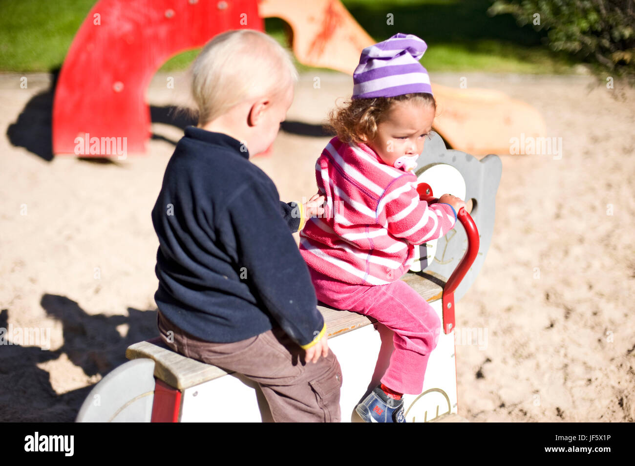 Girl and boy playing on playground Stock Photo - Alamy