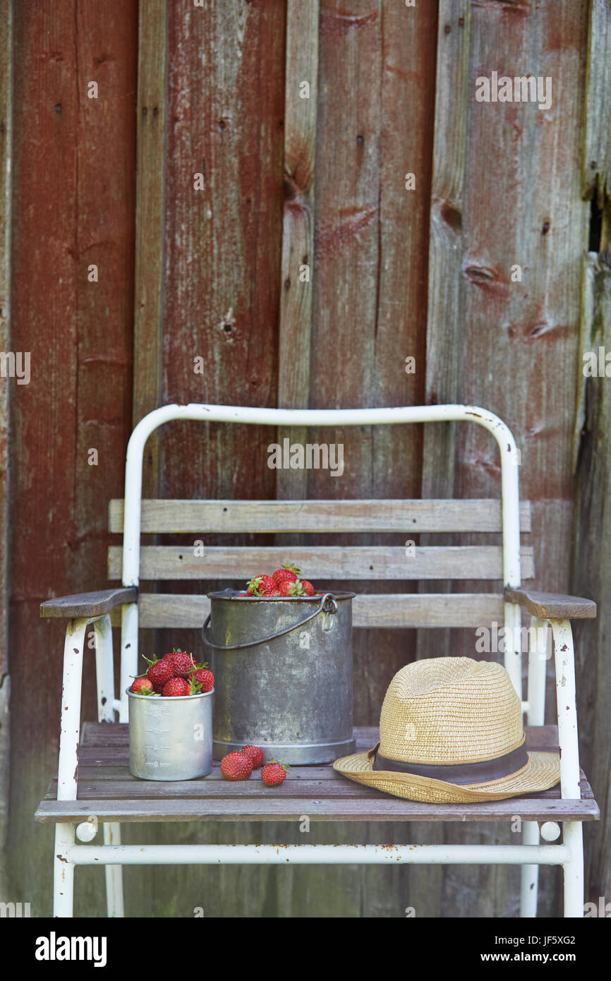 Strawberries in buckets and straw hat Stock Photo - Alamy