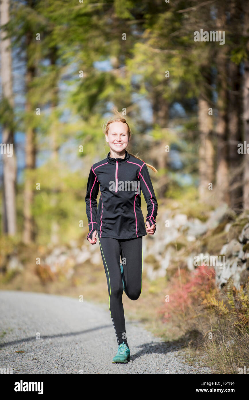Young woman jogging in forest Stock Photo - Alamy