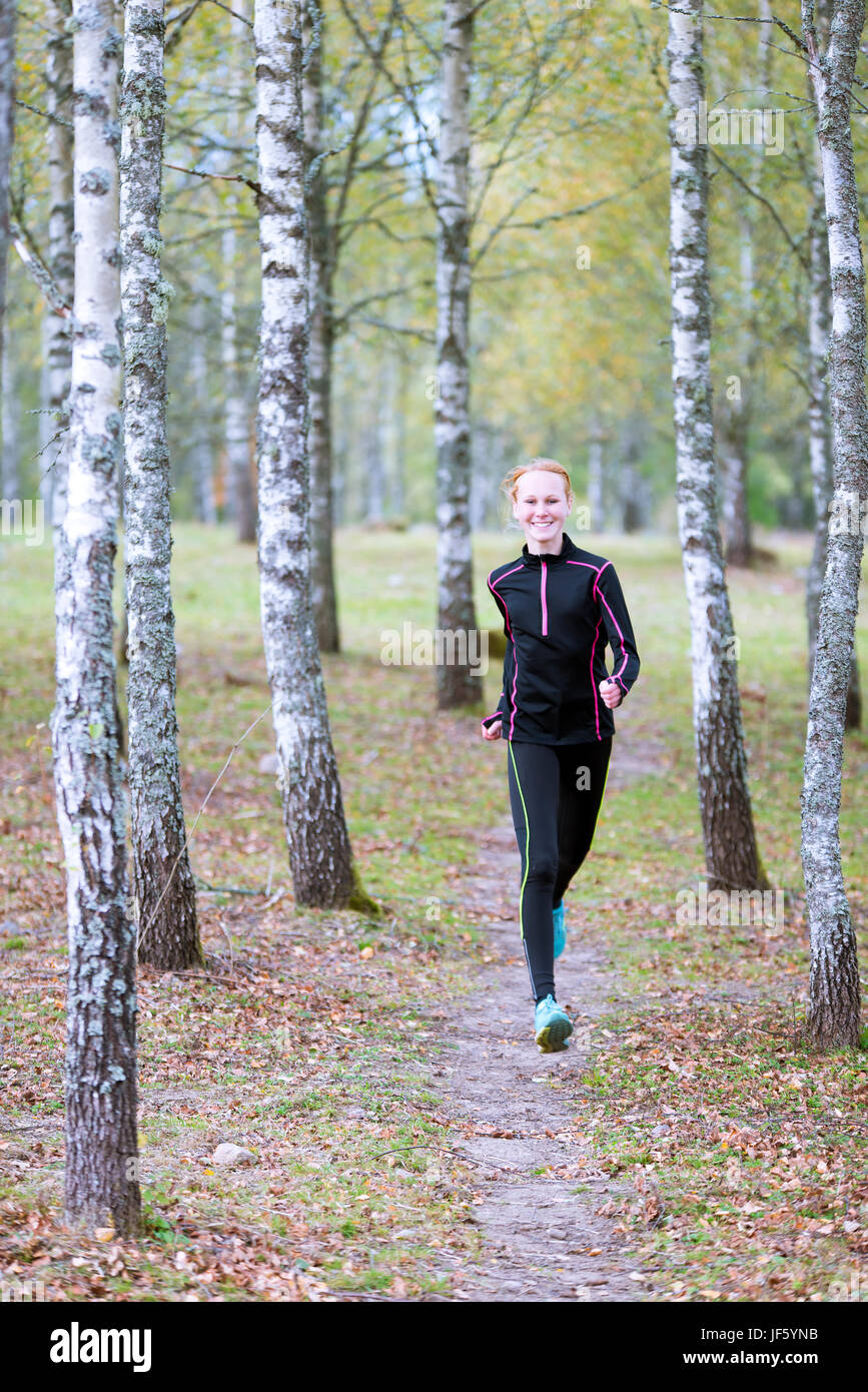 Young woman jogging in forest Stock Photo - Alamy