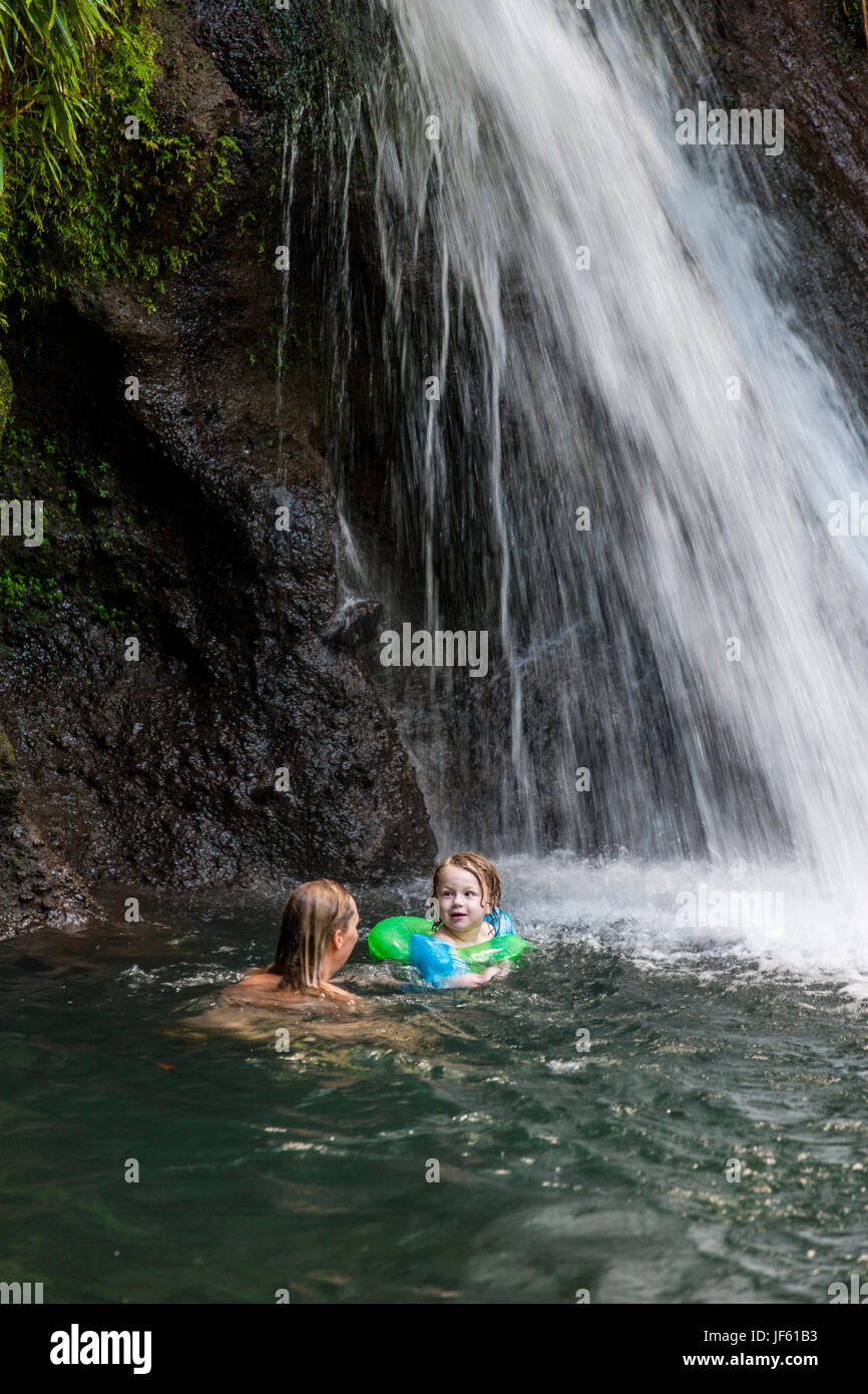 Mother with daughter swimming under waterfall Stock Photo Alamy