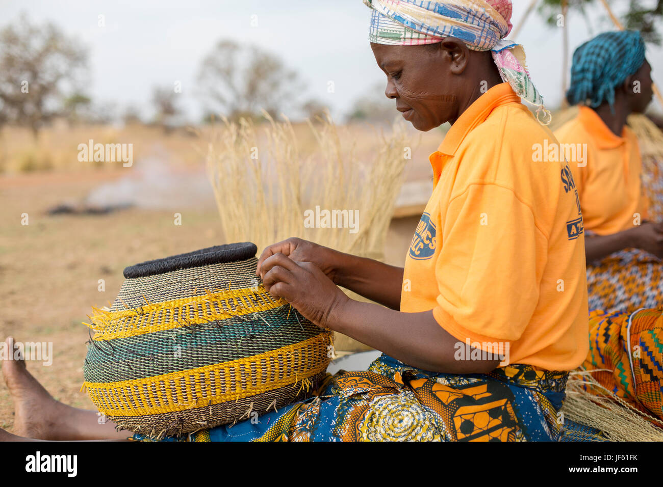 Women from a weaver’s cooperative weave traditional straw baskets
