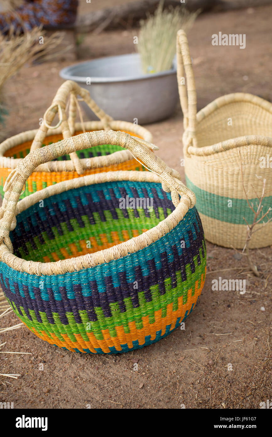 Women from a weaver’s cooperative weave traditional straw baskets