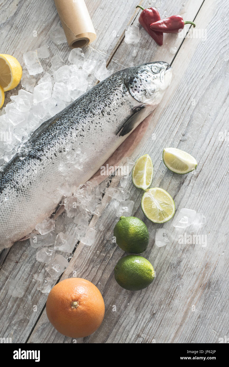 Raw salmon fish in ice and vegetables Stock Photo - Alamy