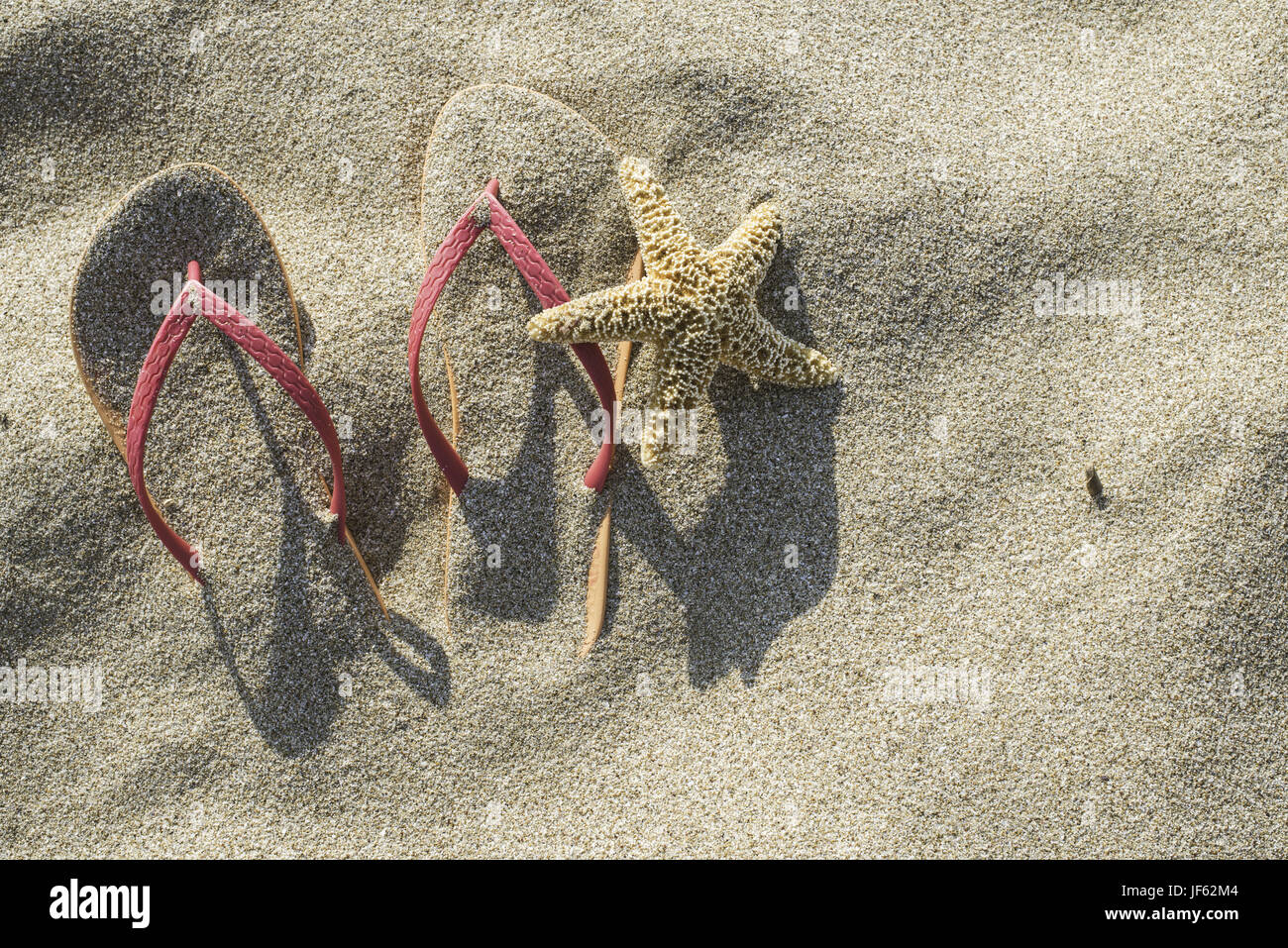 Sandals on the beach in the sand Stock Photo - Alamy