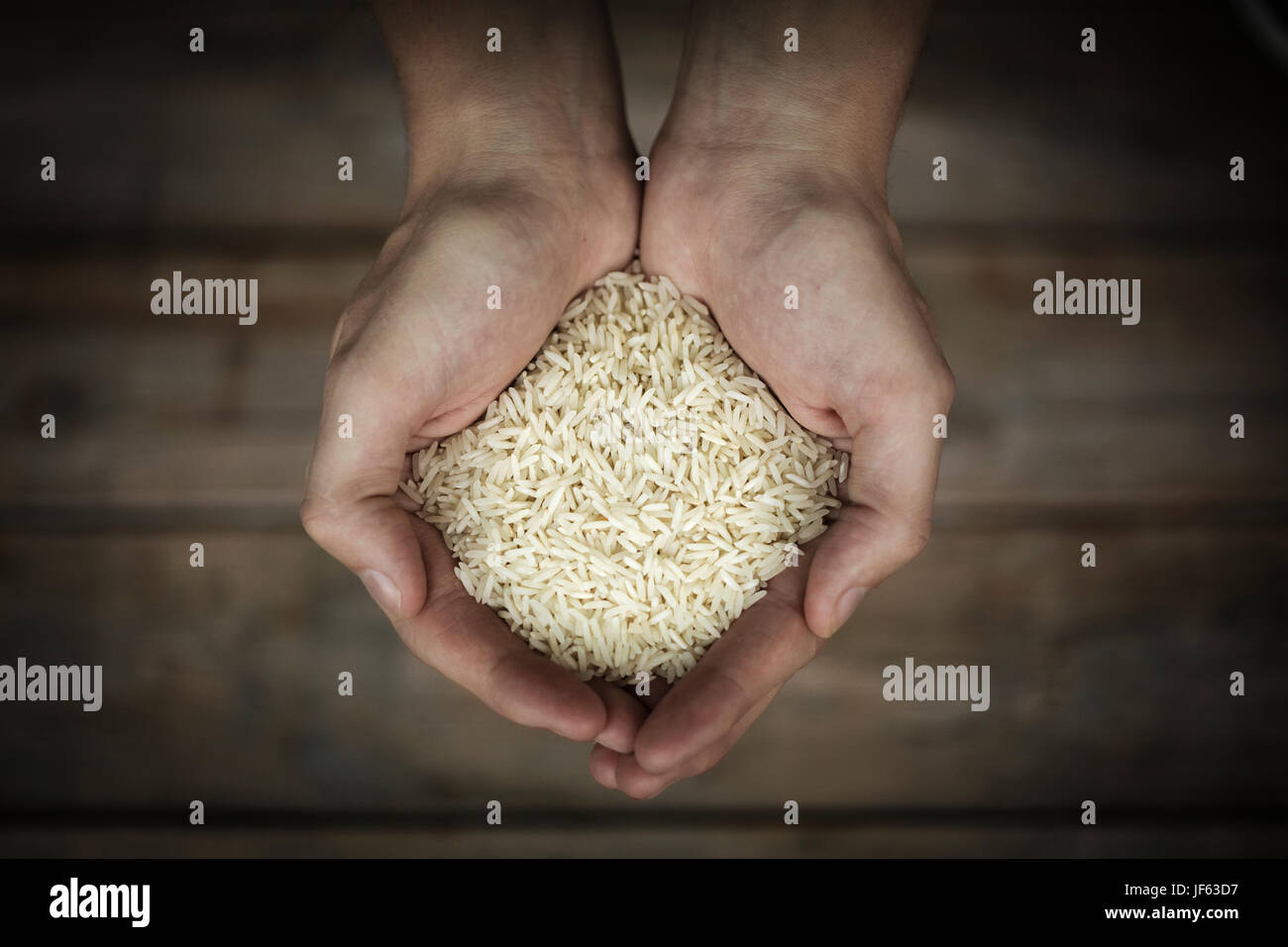 Rice in mans hands, close-up Stock Photo - Alamy