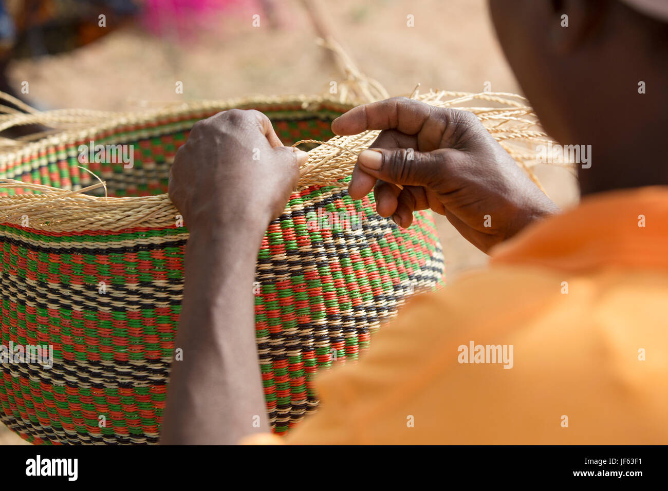 Women from a weaver’s cooperative weave traditional straw baskets